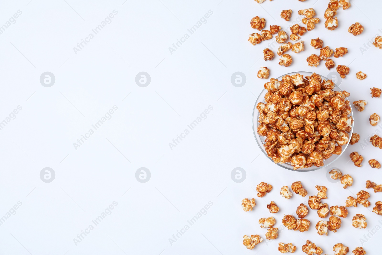 Photo of Flat lay composition with caramel popcorn and space for text on white background