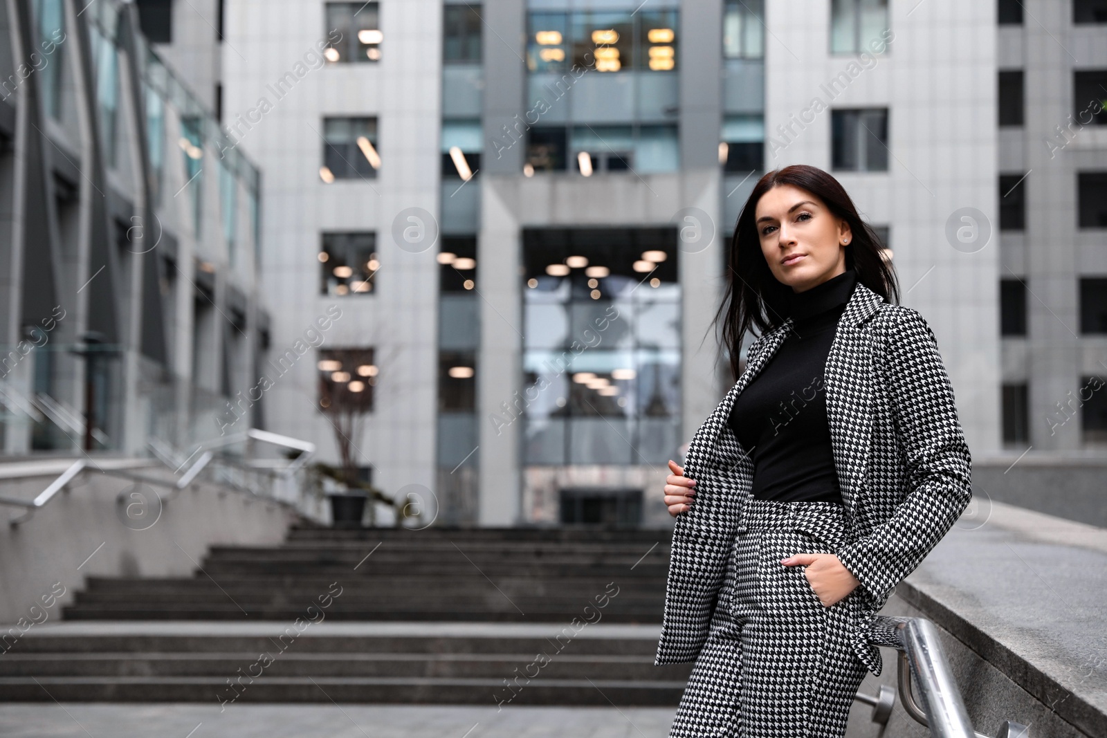 Photo of Portrait of beautiful woman in stylish suit on city street. Space for text