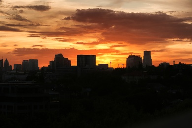 Photo of Silhouette of city with buildings against sky at sunset