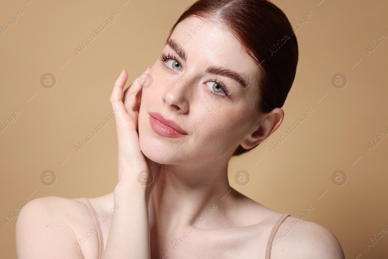 Photo of Portrait of beautiful woman on beige background, closeup