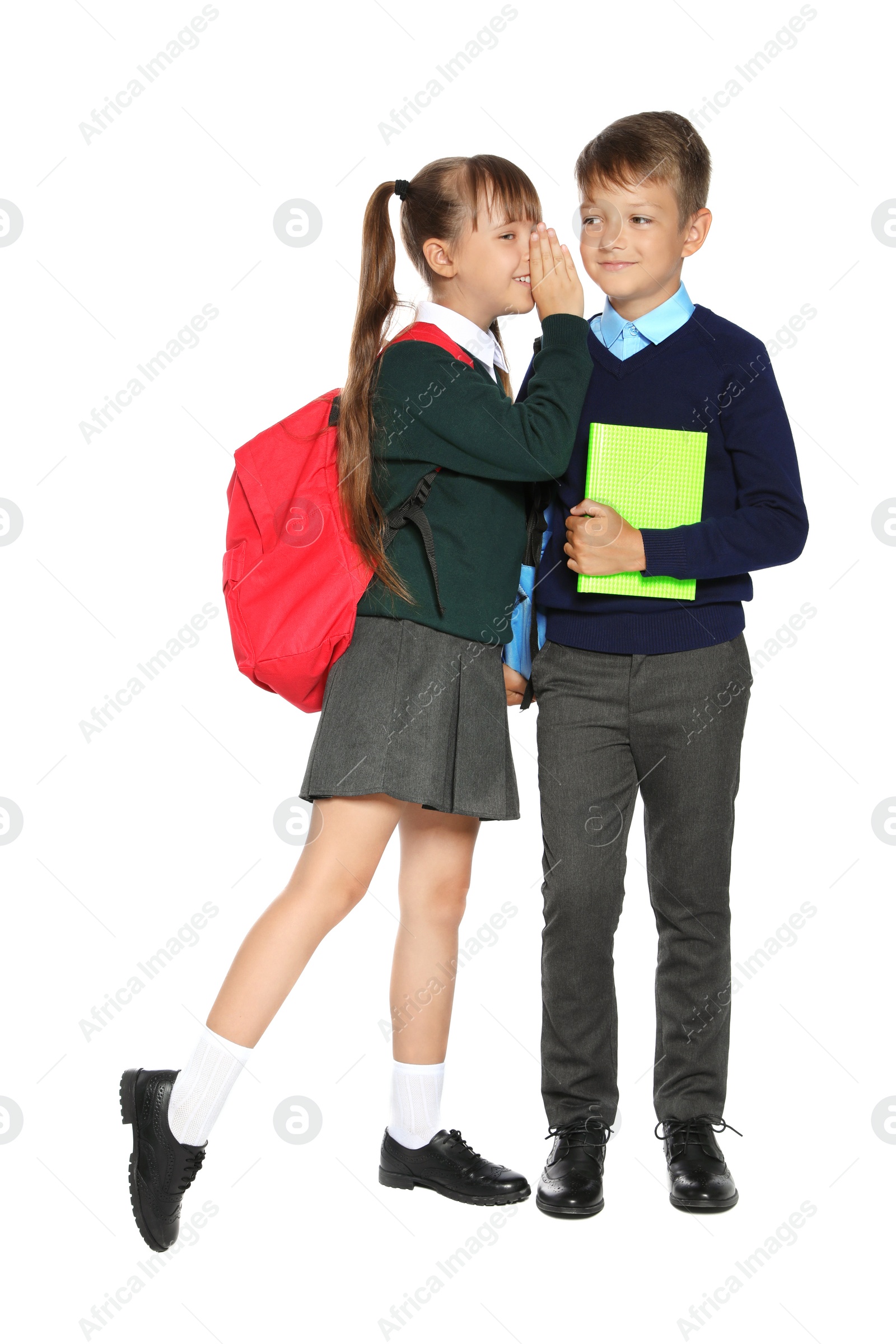 Photo of Little children in stylish school uniform on white background