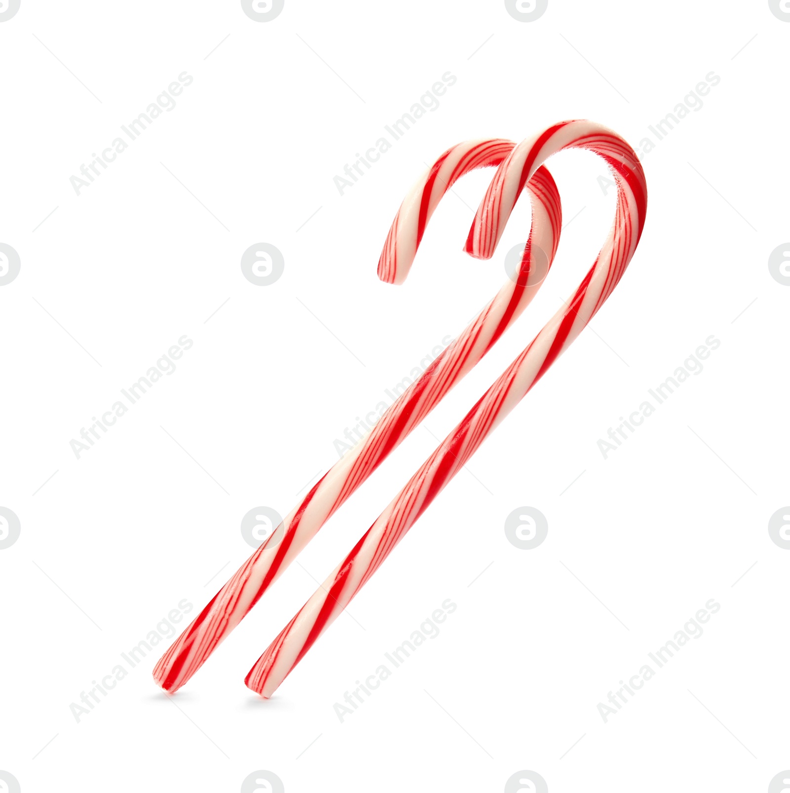 Photo of Tasty candy canes on white background. Festive treat