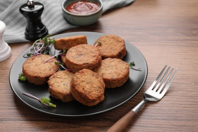 Photo of Delicious vegan cutlets served on wooden table