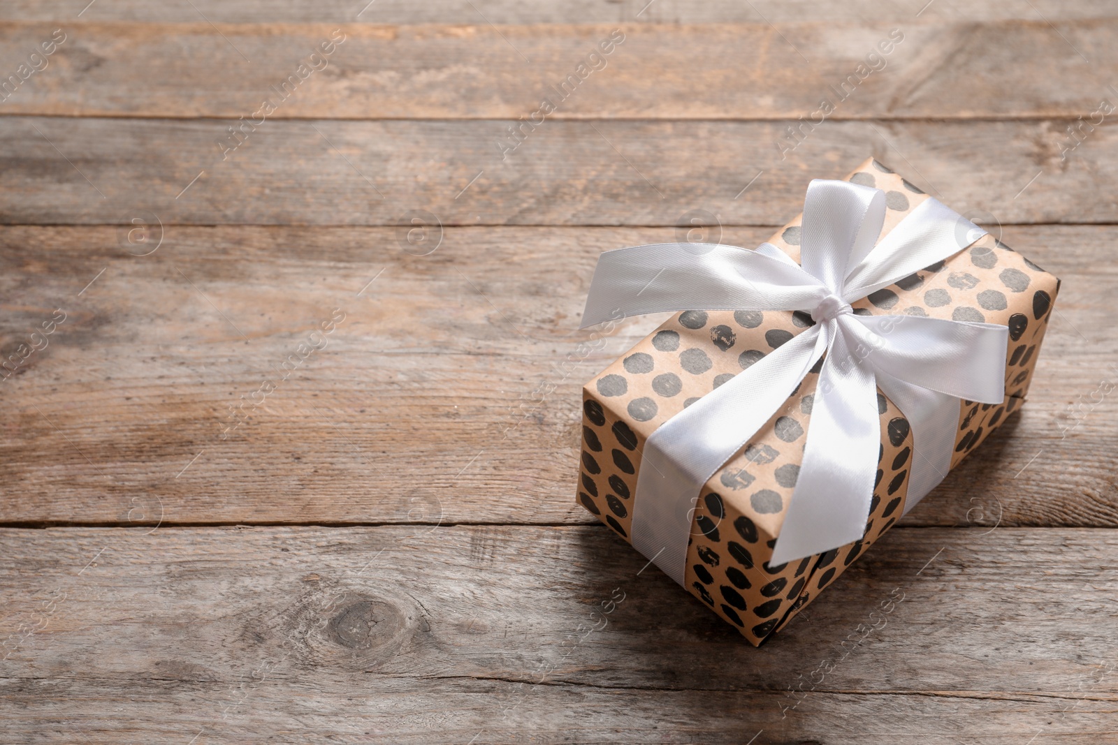 Photo of Beautiful gift box on wooden background