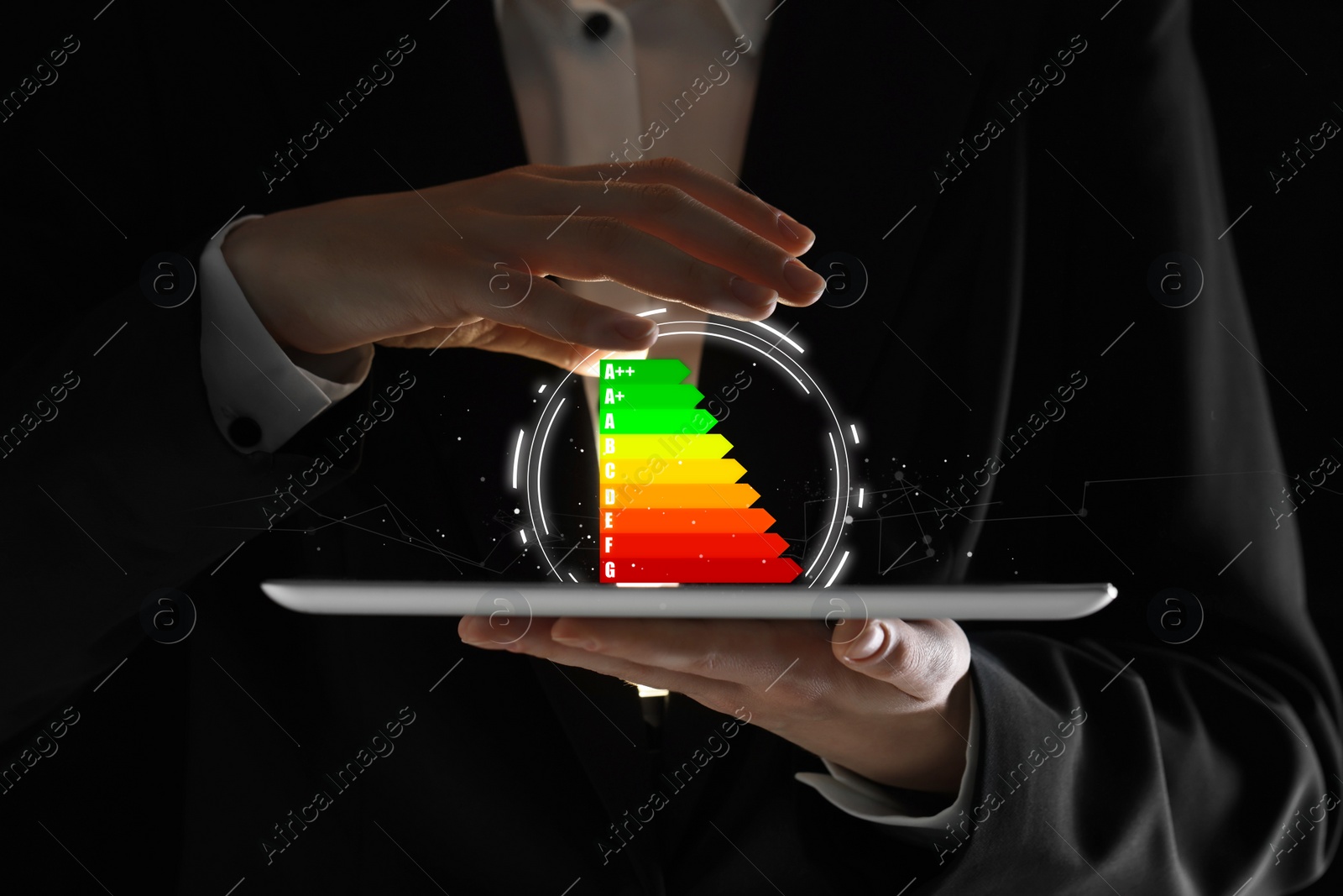 Image of Energy efficiency rating coming out of tablet. Man using device, closeup