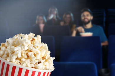 Image of Popcorn and young people in cinema, space for text 