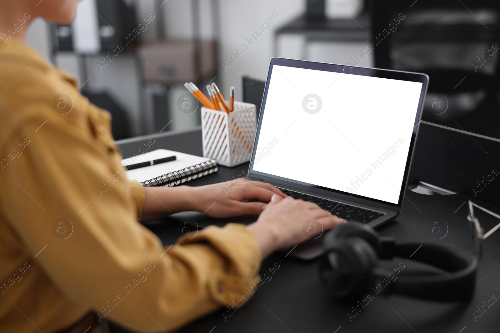 Photo of Woman watching webinar at table in office, closeup