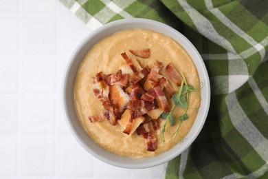 Photo of Delicious lentil soup with bacon and croutons on white tiled table, top view