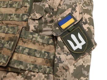 Soldier with Ukrainian flag and trident on military uniform against white background, closeup
