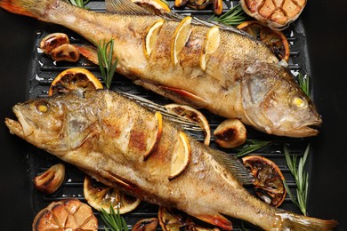 Photo of Tasty homemade roasted perches in grill pan, flat lay. River fish