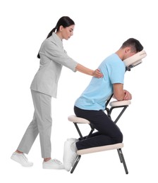 Photo of Man receiving massage in modern chair on white background