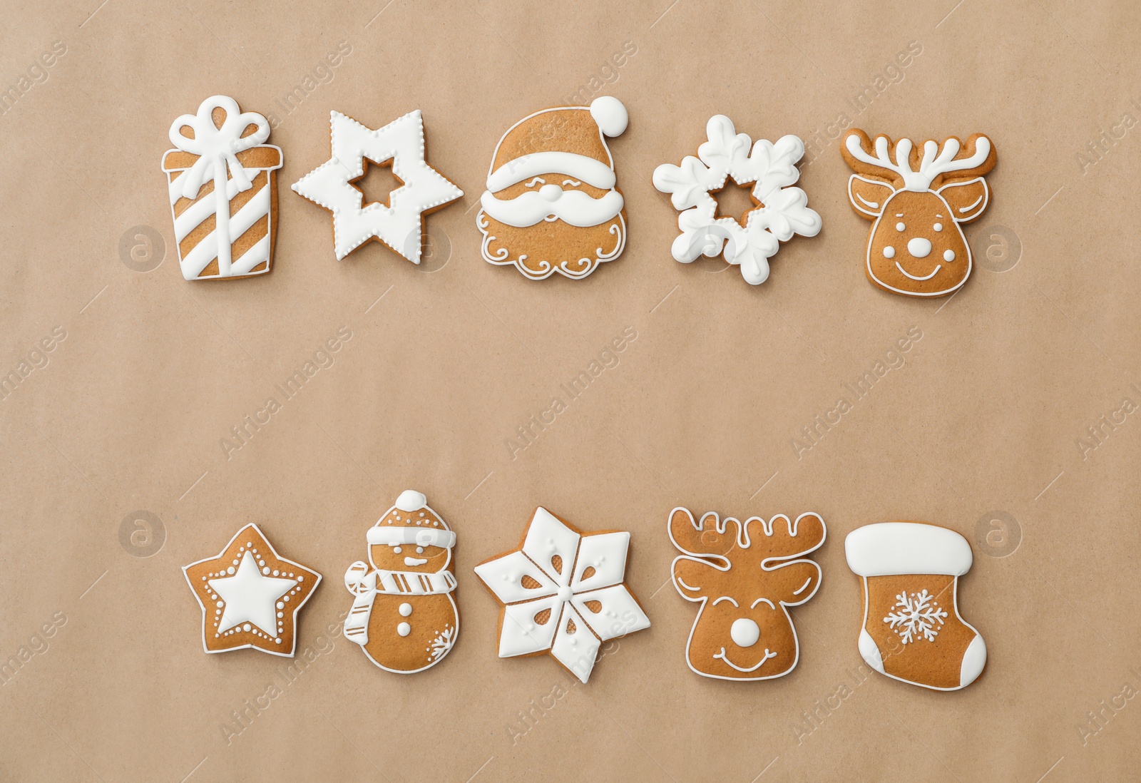 Photo of Different Christmas gingerbread cookies on brown background, flat lay. Space for text