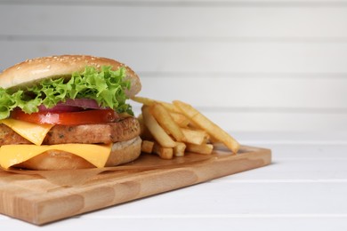 Delicious tofu burger served with french fries on white table. Space for text