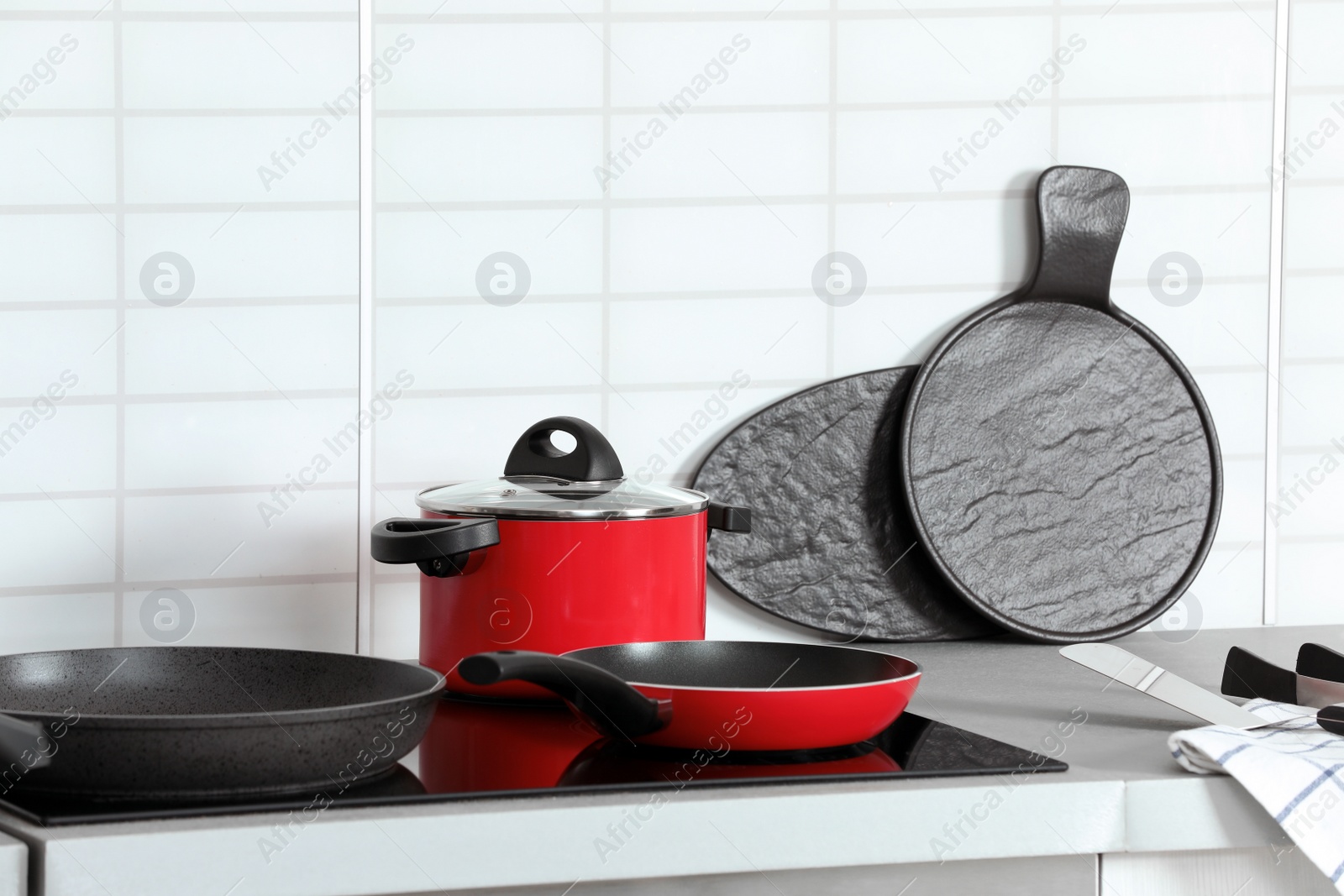 Photo of Different clean cookware on stove in kitchen. Space for text