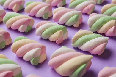 Delicious colorful marshmallows on violet background, closeup