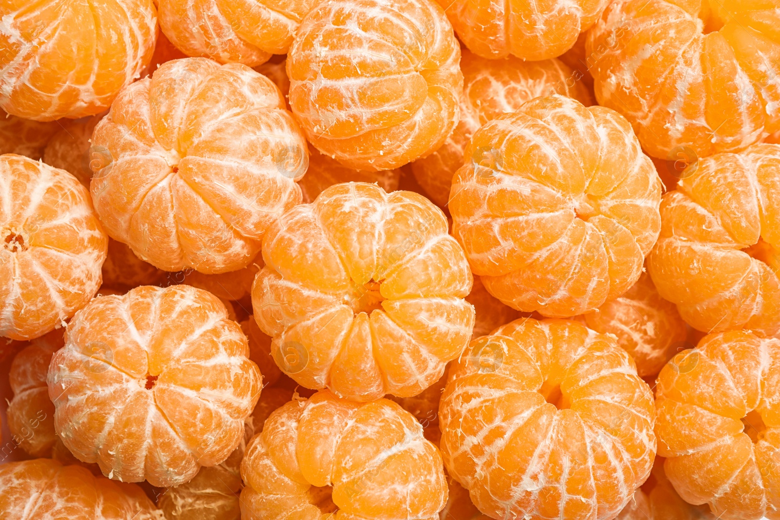 Photo of Peeled fresh ripe tangerines as background, top view