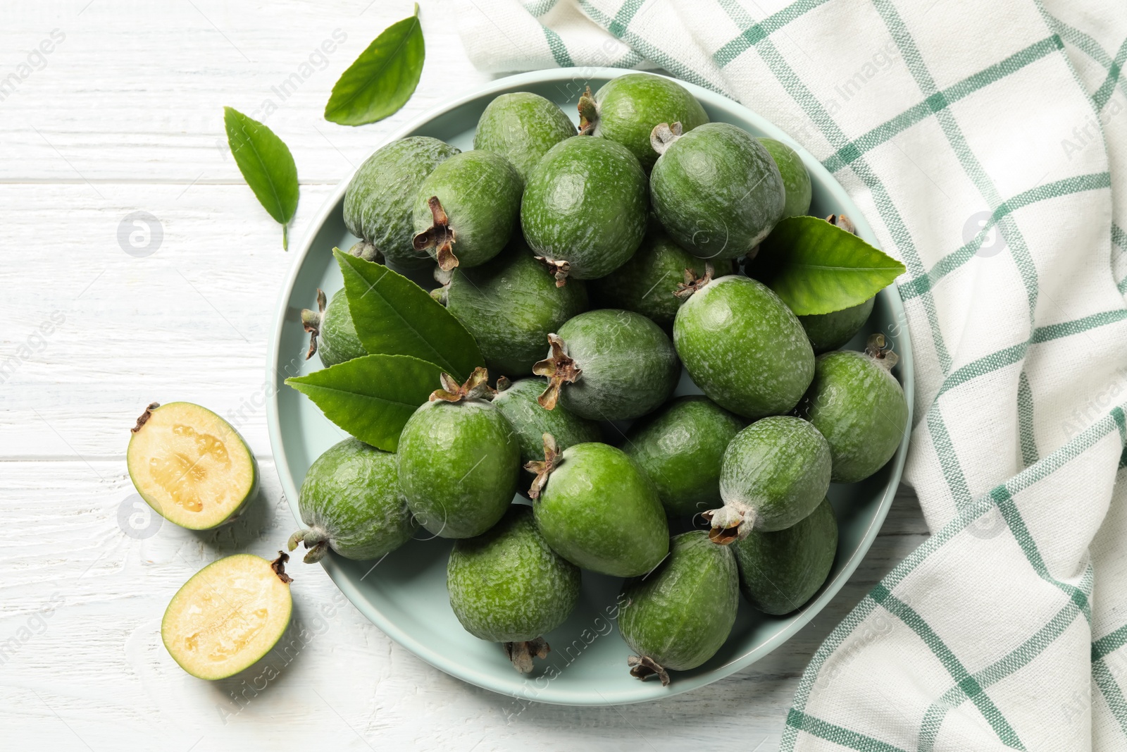 Photo of Flat lay composition with fresh green feijoa fruits on white wooden table