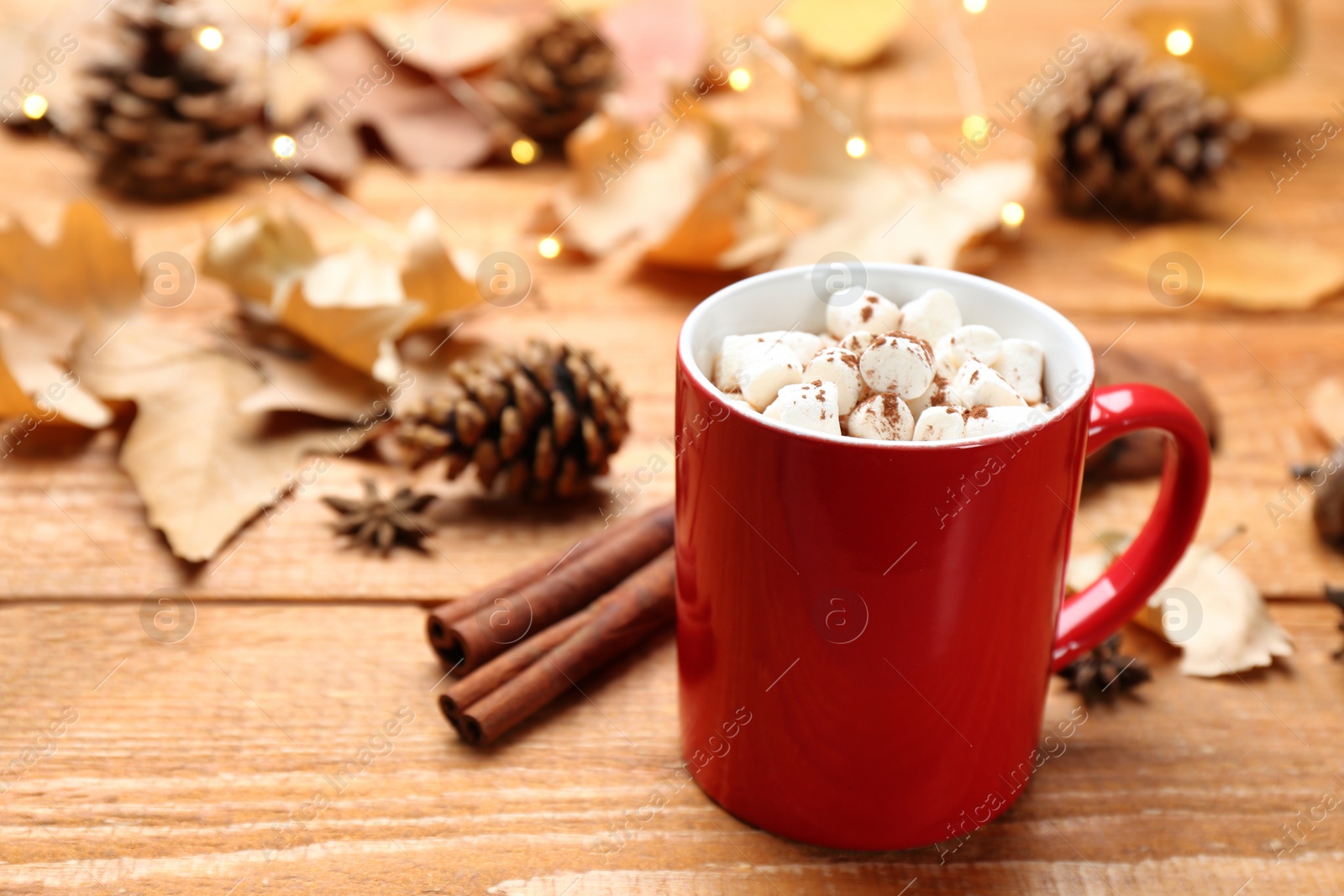 Photo of Cup of hot drink on wooden table. Cozy autumn atmosphere