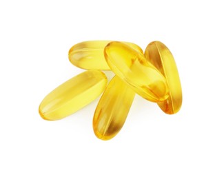 Photo of Many yellow vitamin capsules isolated on white, top view