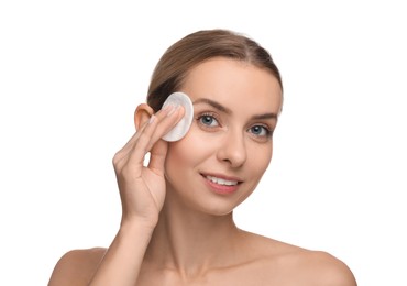 Photo of Smiling woman removing makeup with cotton pad on white background
