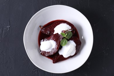 Tasty red wine poached pears and ice cream on black table, top view
