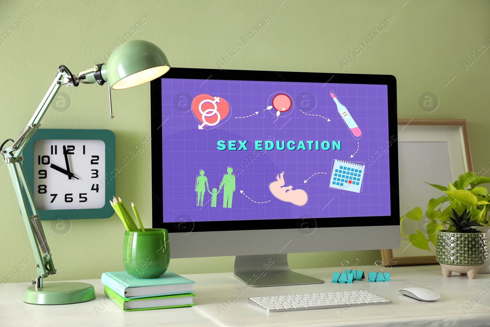 Image of Sex education. Modern computer with open program on table near light green wall