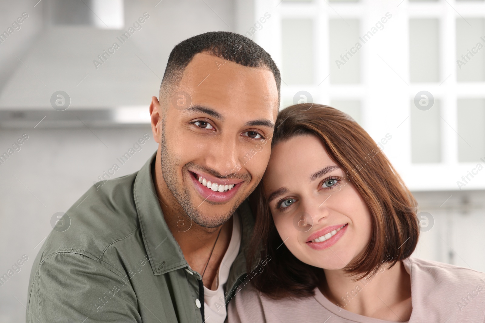 Photo of Dating agency. Portrait of happy couple in kitchen, closeup