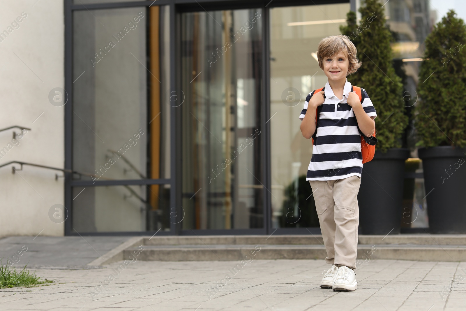 Photo of Portrait of little boy walking to kindergarten outdoors. Space for text