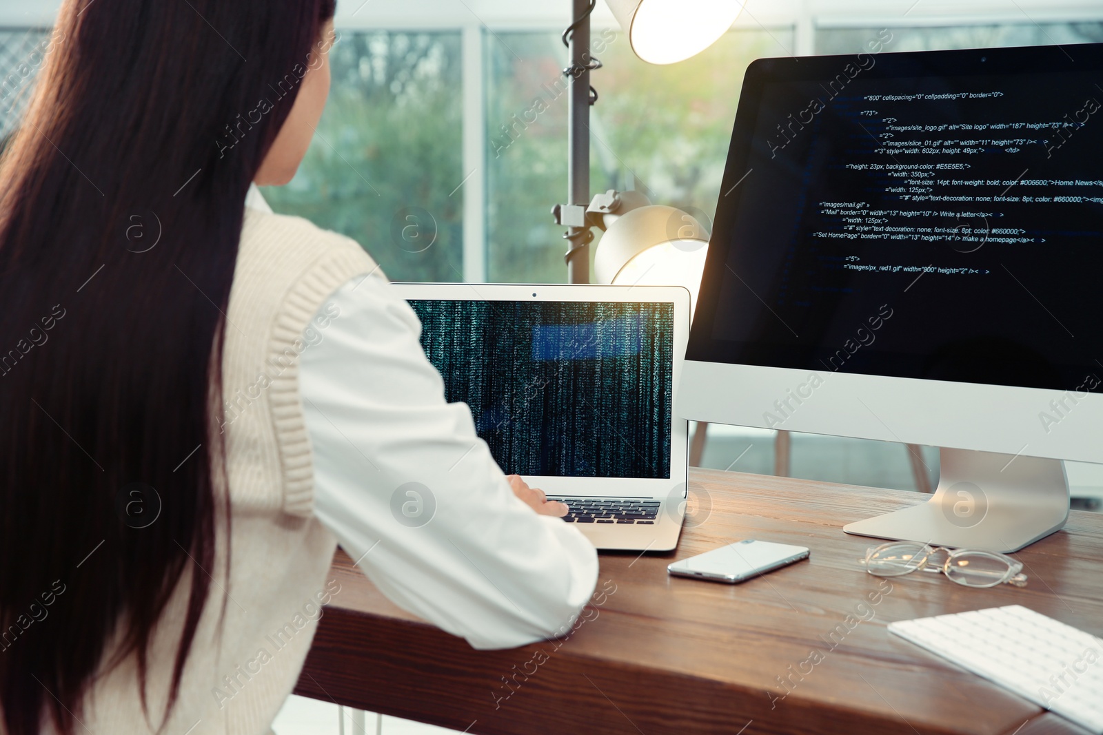 Photo of Programmer working at desk in modern office