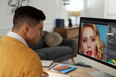 Photo of Professional retoucher working on computer in office