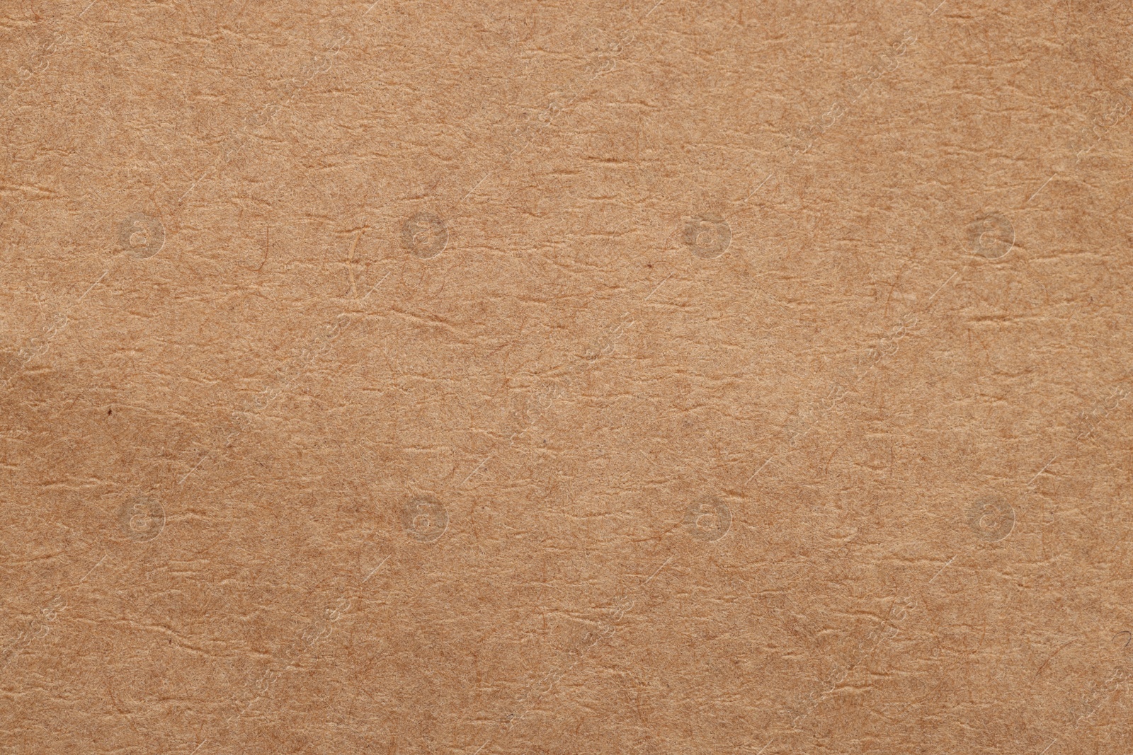 Photo of Texture of beige paper sheet as background, top view