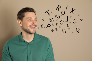 Image of Smiling man and letters on beige background. Speech therapy concept