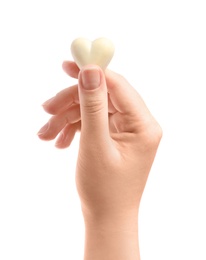Woman holding heart shaped chocolate candy on white background, closeup