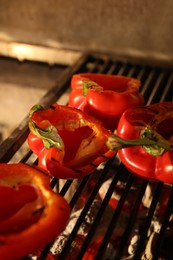 Cooking delicious fresh bell peppers on grilling grate in oven