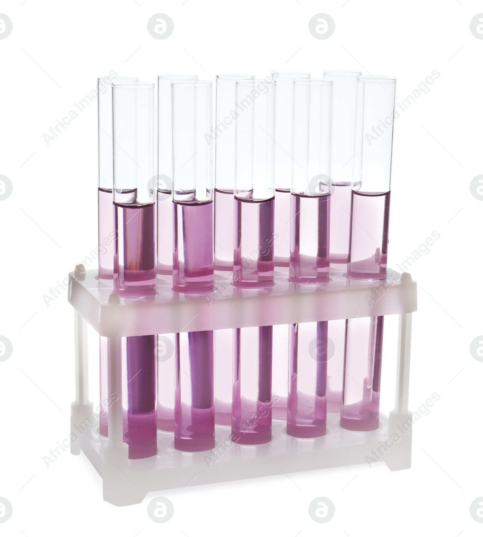 Photo of Test tubes with pink liquid on white background