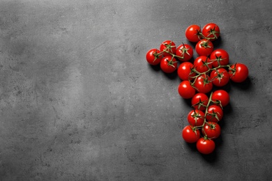 Photo of Fresh cherry tomatoes on stone background, flat lay. Space for text