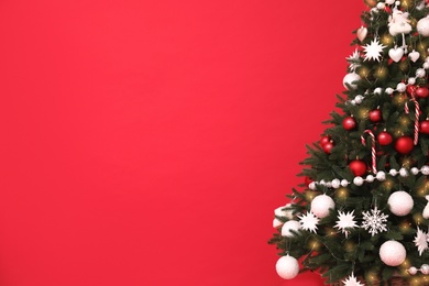 Christmas tree on red background, space for text