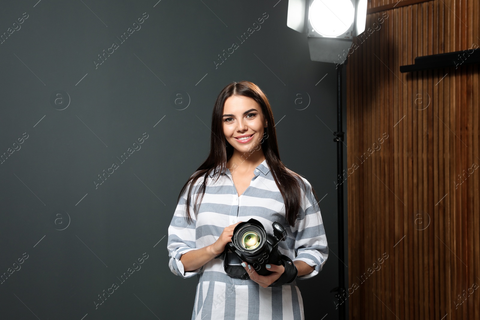 Photo of Professional photographer with modern camera in studio