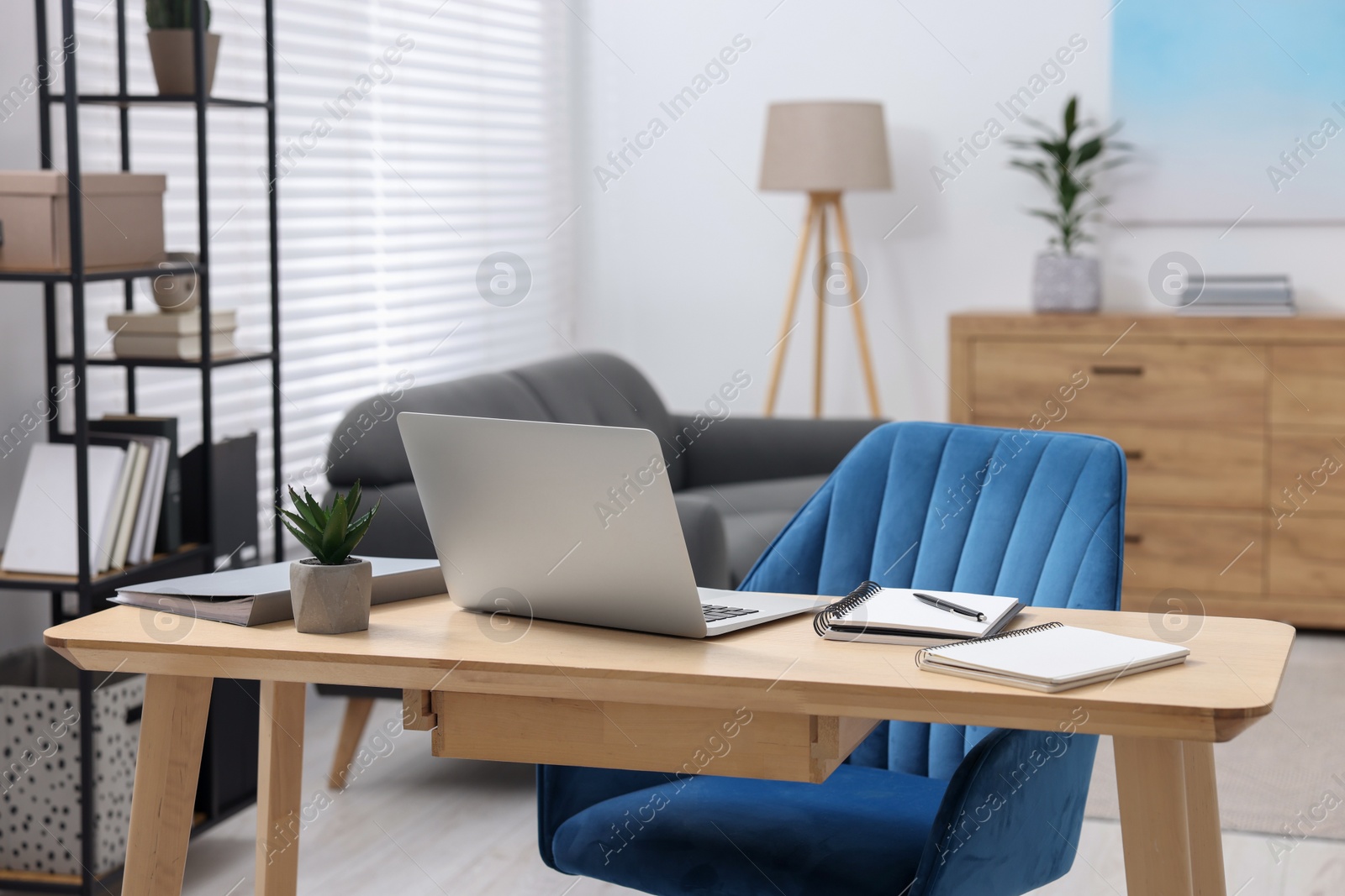 Photo of Home workspace. Laptop and stationery on wooden desk indoors