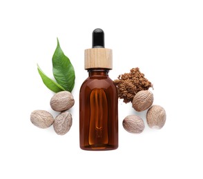 Photo of Bottle of nutmeg oil, nuts and powder on white background, top view