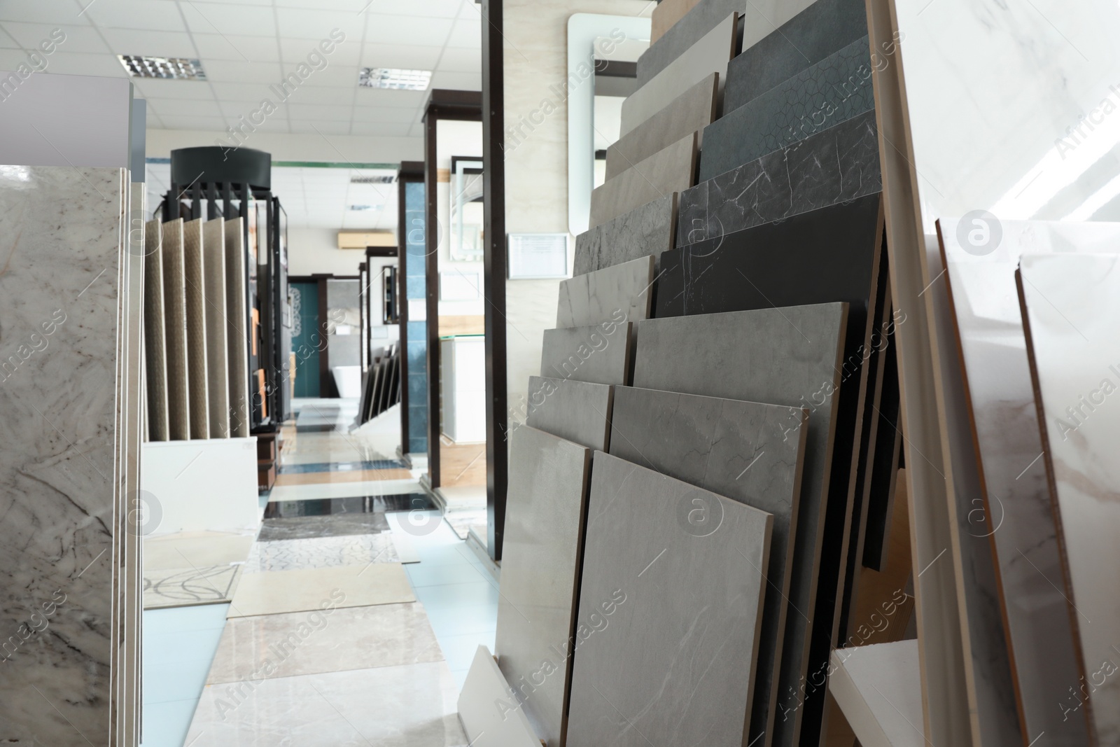 Photo of Assortment of tiles in store. Many different samples indoors