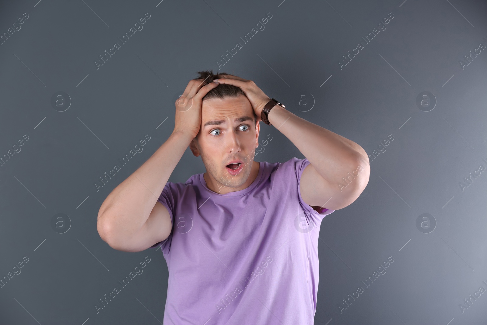 Photo of Handsome emotional young man on color background