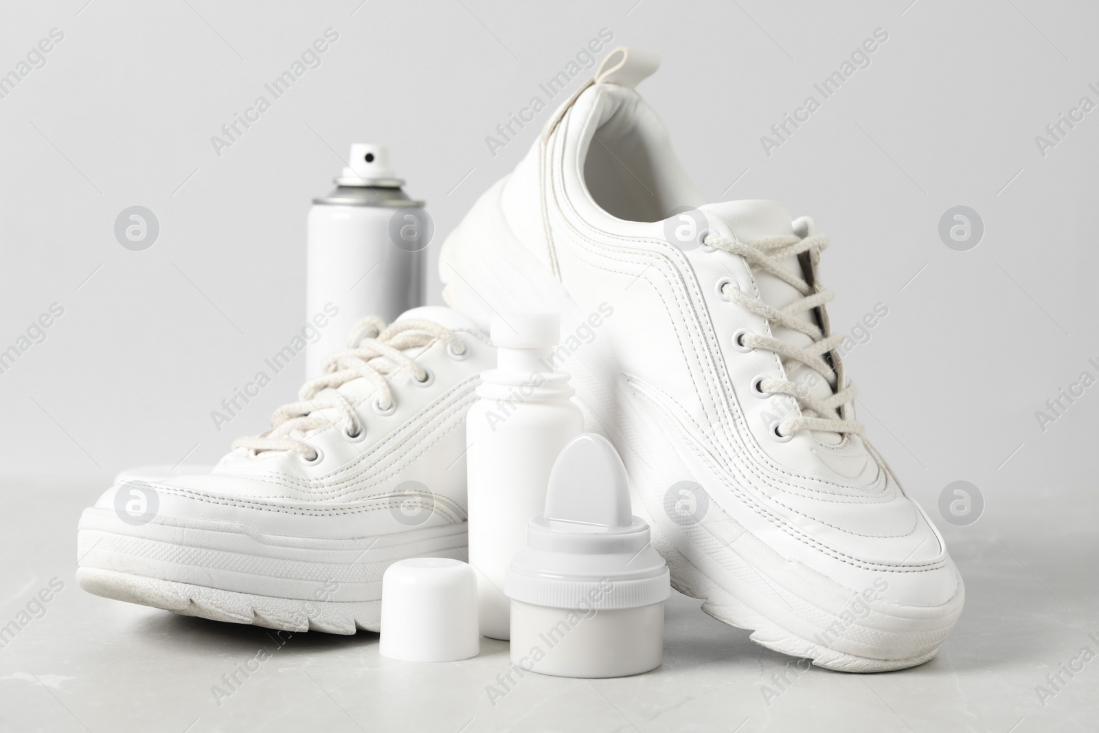 Photo of Composition with stylish footwear and shoe care accessories on white background