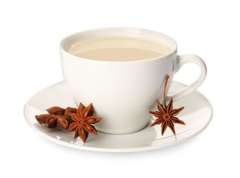 Photo of Cup of tea with milk and anise stars on white background