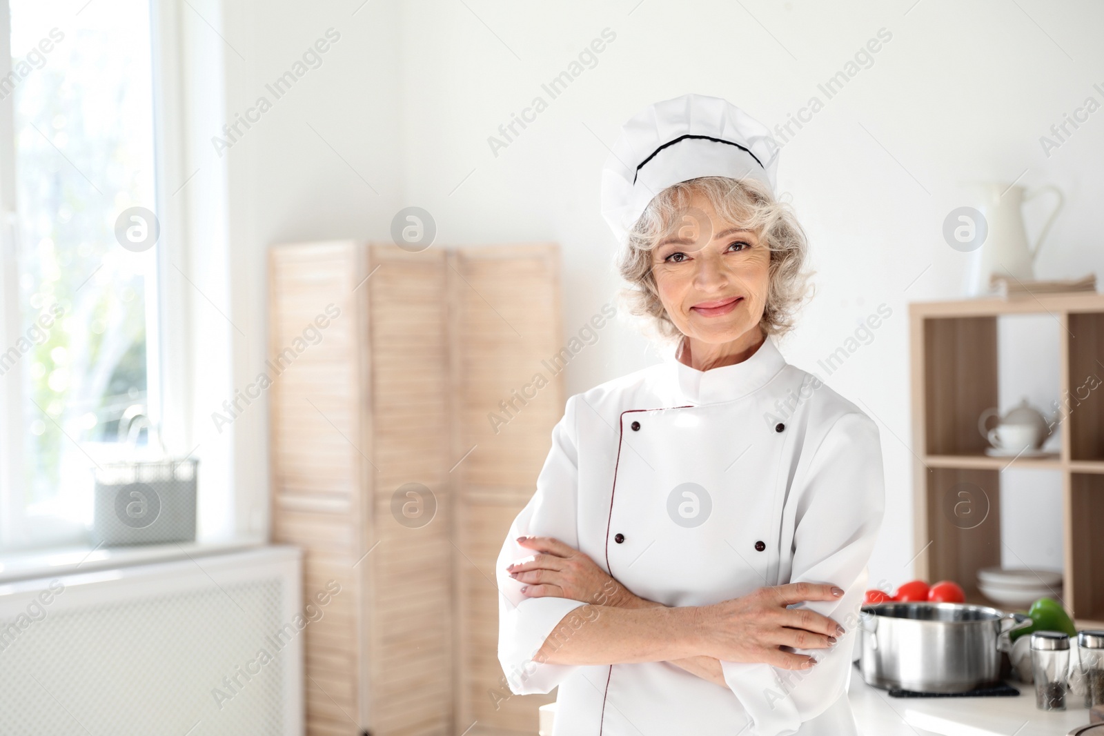 Photo of Professional female chef wearing uniform in kitchen