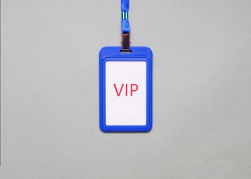 Photo of Plastic vip badge on light gray background, top view