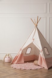 Cute child room interior with play tent near white wall