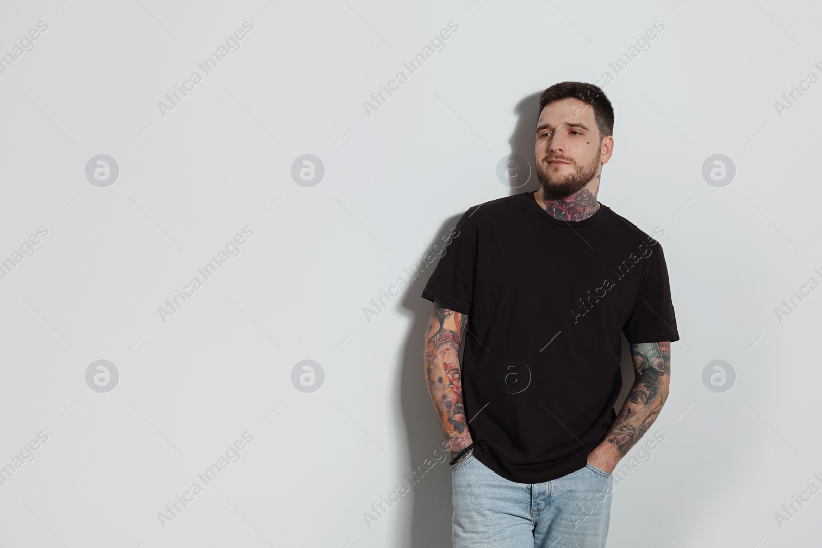 Photo of Handsome hipster man on light grey background. Space for text