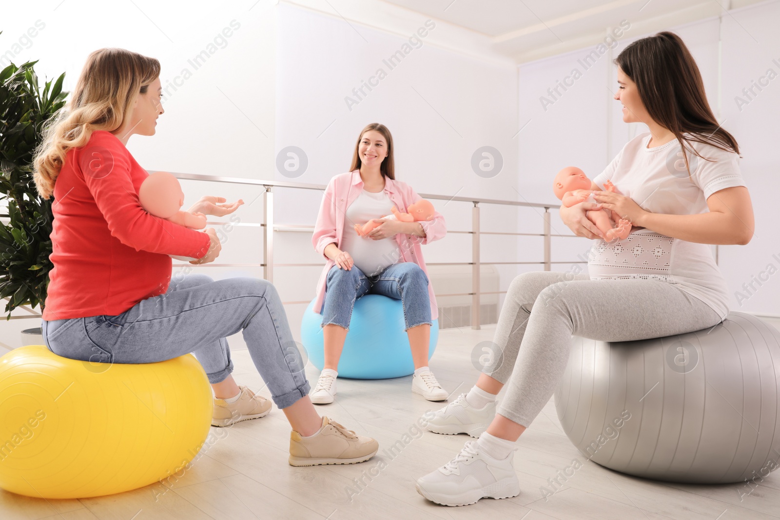 Photo of Group of pregnant women at courses for expectant mothers indoors