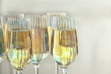 Glasses of champagne on blurred background, closeup view